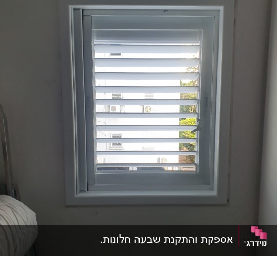 תריסי אלומיניום לבנים בחלון